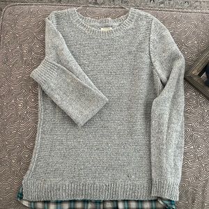Cute light gray sweater with a flannel trim on the bottom!